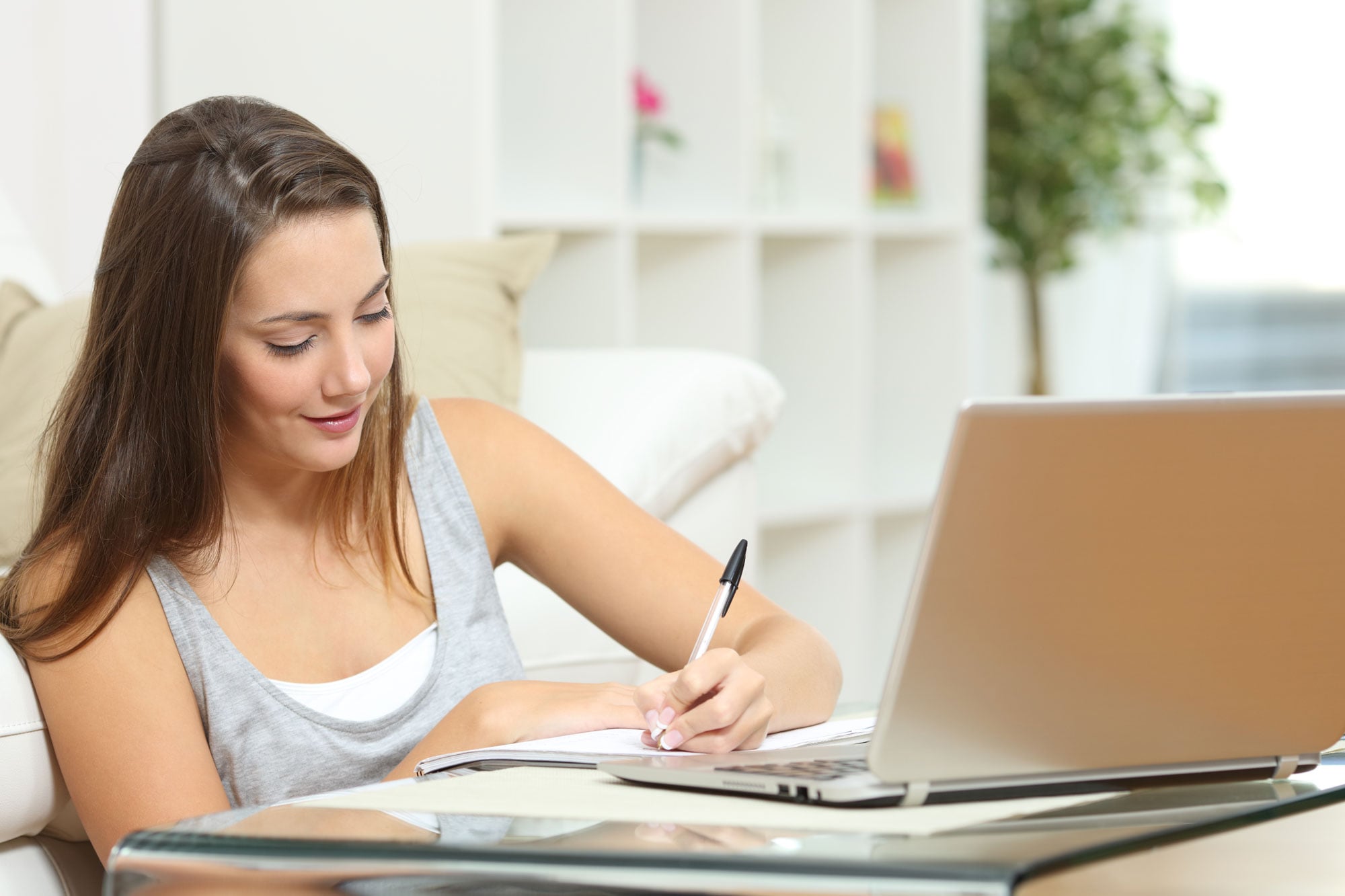 teen girl doing homework, writing in a notebook. online high school oregon